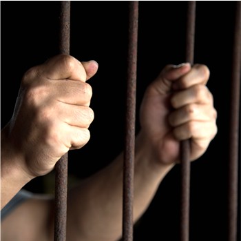 ClayCoNews Stock image-hands of prisoner in jail