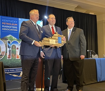 Kentucky Attorney General Russell Coleman receives the KPMA 2024 Energy Advocate Award from Chairman Scott Kiser of Woodford Oil, left and Executive Director Brian Clark, right