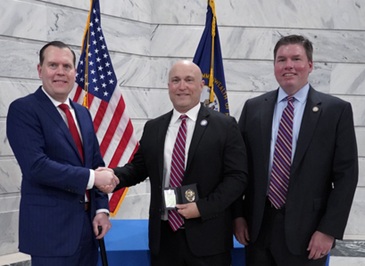Attorney General Russell Coleman (L) and Deputy Attorney General Rob Duncan (R) congratulate Special Prosecutor Richie Kemp during his swearing in ceremony.