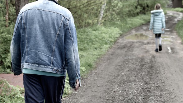 Girl alone walks in forest and followed by stranger man