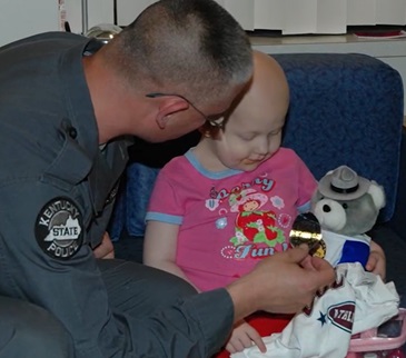 KSP Trooper presents a Trooper Teddy Bear to a child: https://www.clayconews.com/