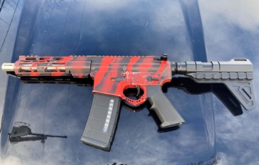 .223 caliber semiautomatic rifle painted to look fake: https://www.clayconews.com/